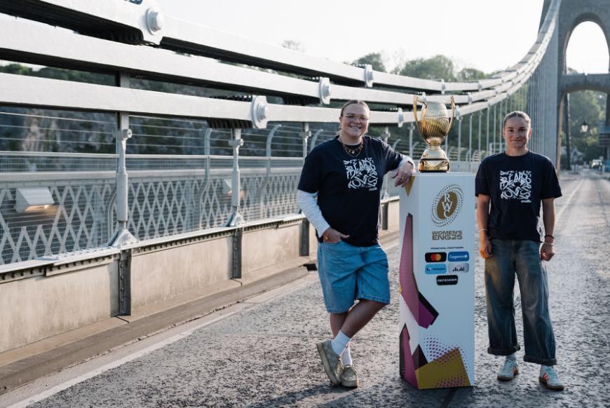 two rugby women's players standing next to the cup on the Clifton suspension bridge